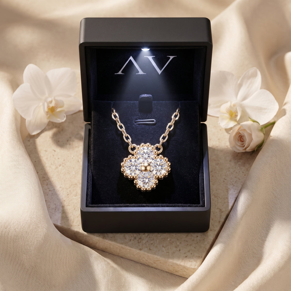 Gold moissanite clover pendant in LED-lit gift box.