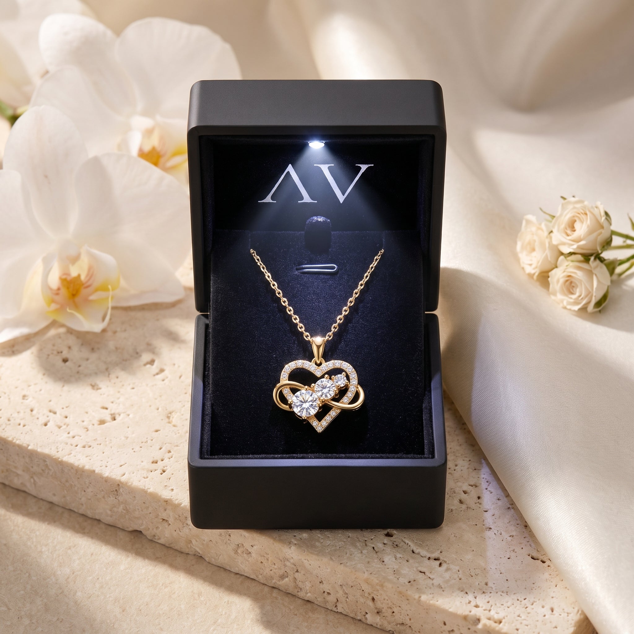 Gold Aureliette moissanite heart necklace inside a black LED-lit presentation box.