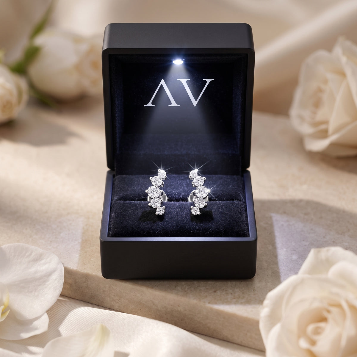 Silver moissanite climber earrings in a black LED-lit AV branded jewelry box.