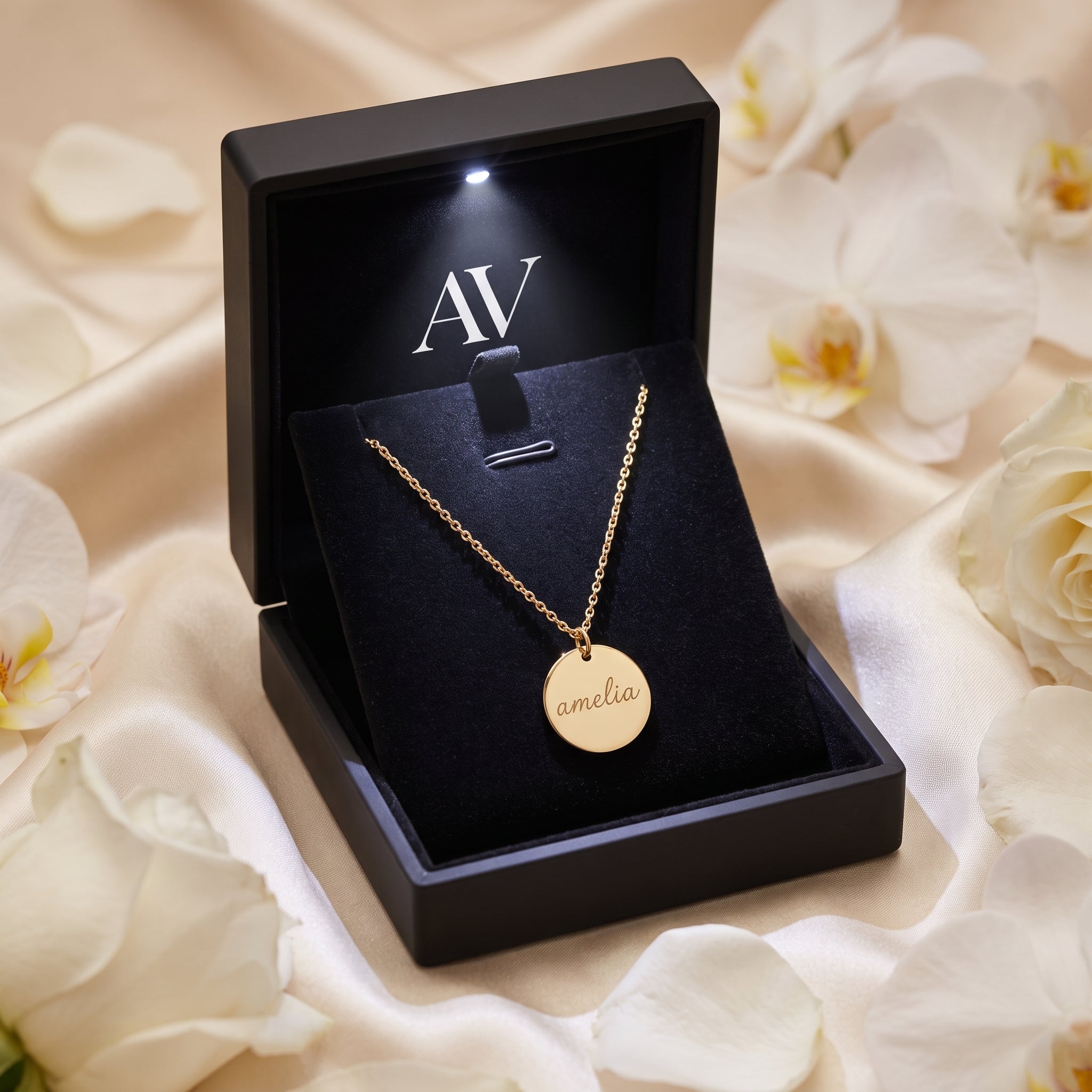 Gold Eloise necklace inside a premium black LED-lit gift box with floral decor.