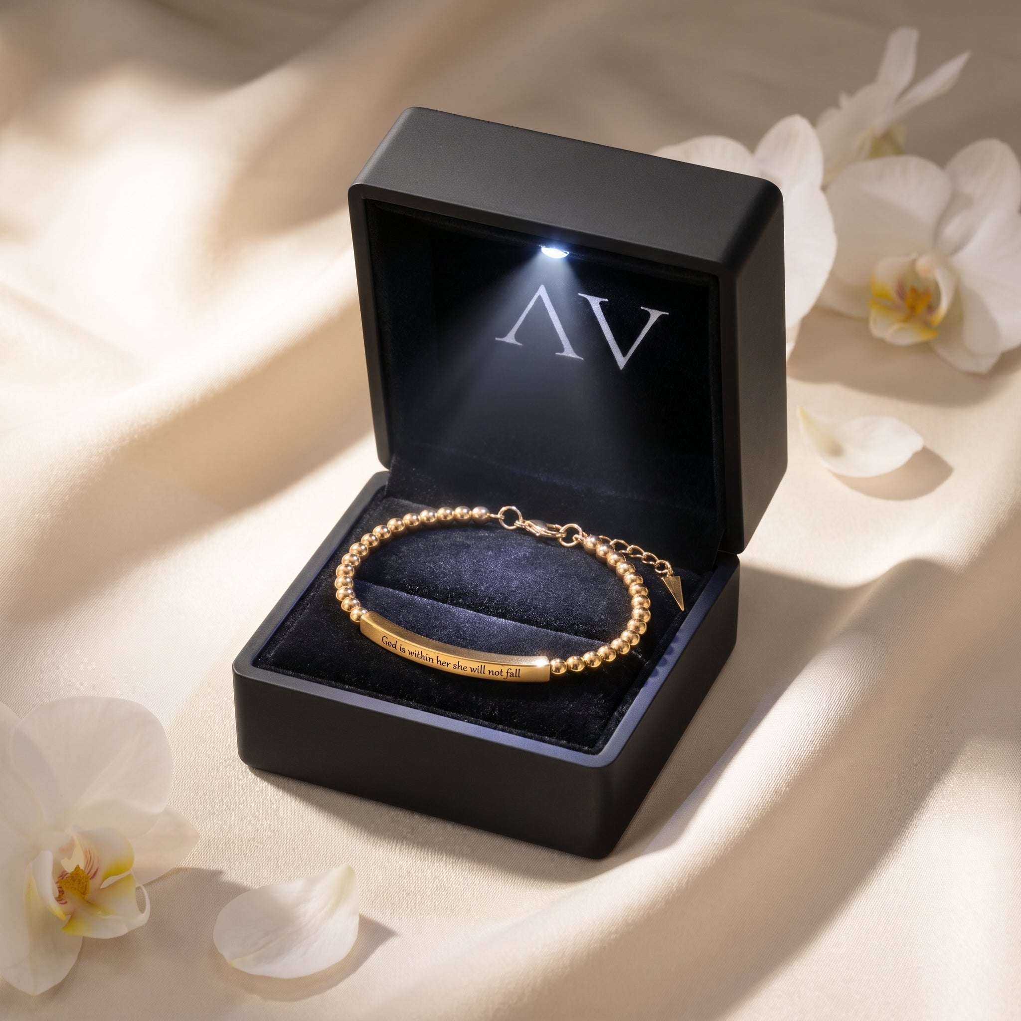Gold beaded bar bracelet displayed inside a black LED-lit jewelry gift box.