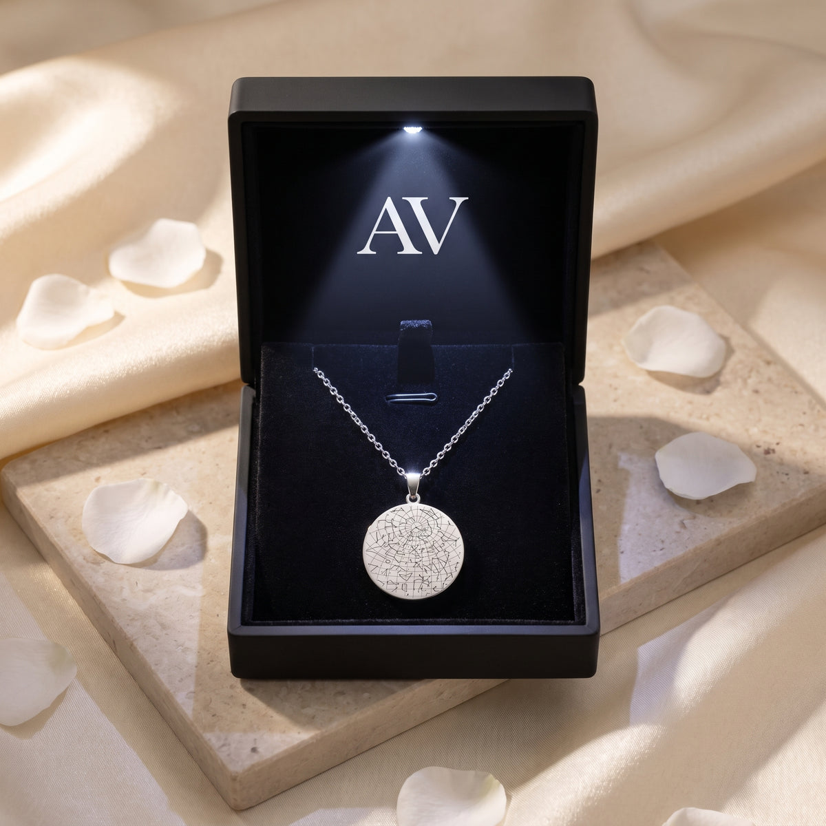Silver stainless steel star map necklace in a black LED-lit gift box.