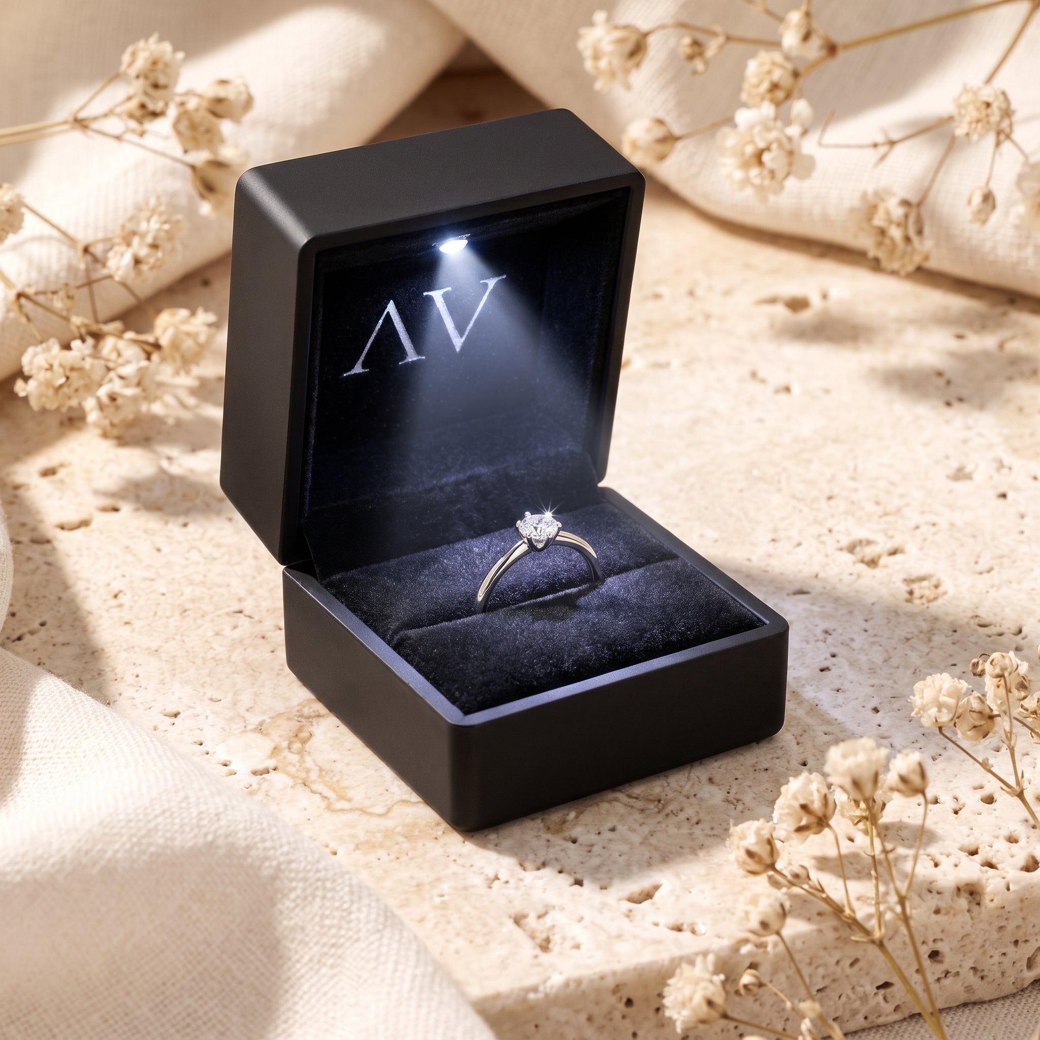 Silver moissanite ring inside a black LED-lighted jewelry box.