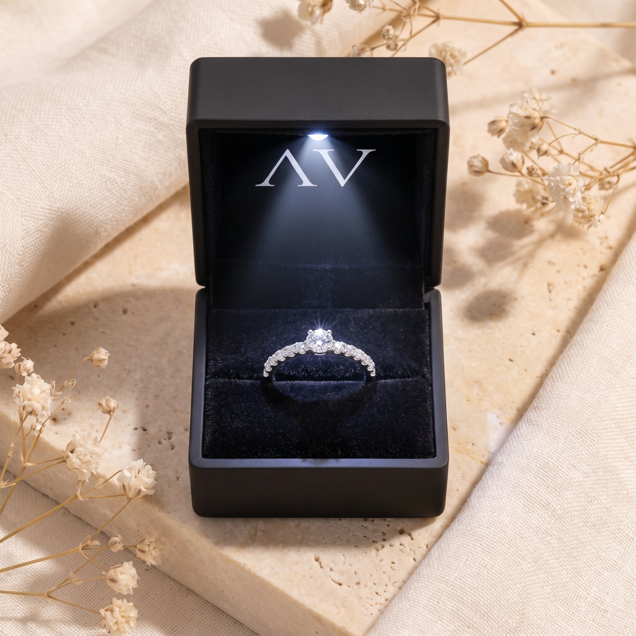 Sterling silver moissanite ring in a black luxury LED-lit gift box.