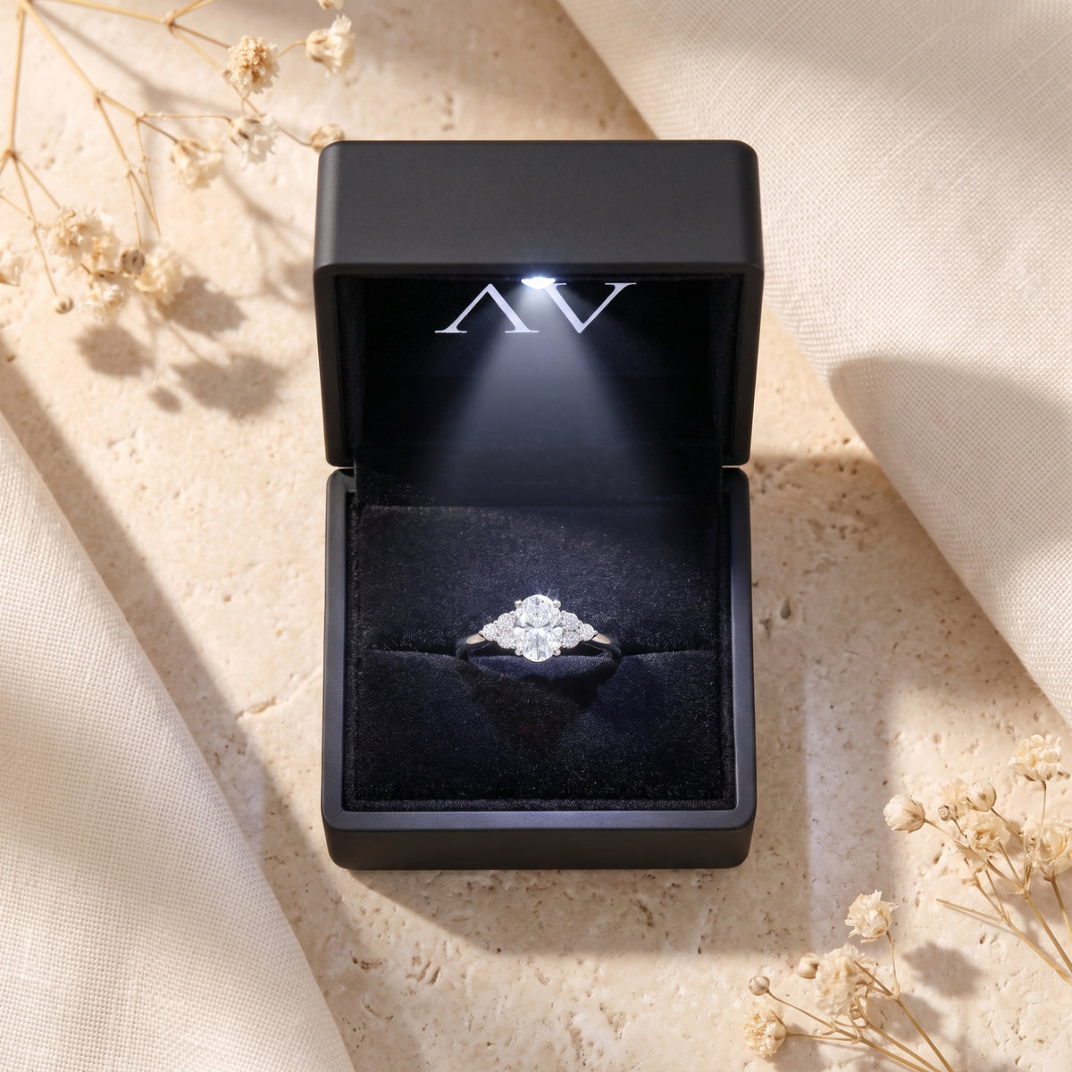 Oval moissanite ring presented in a premium black LED-lit jewelry gift box.