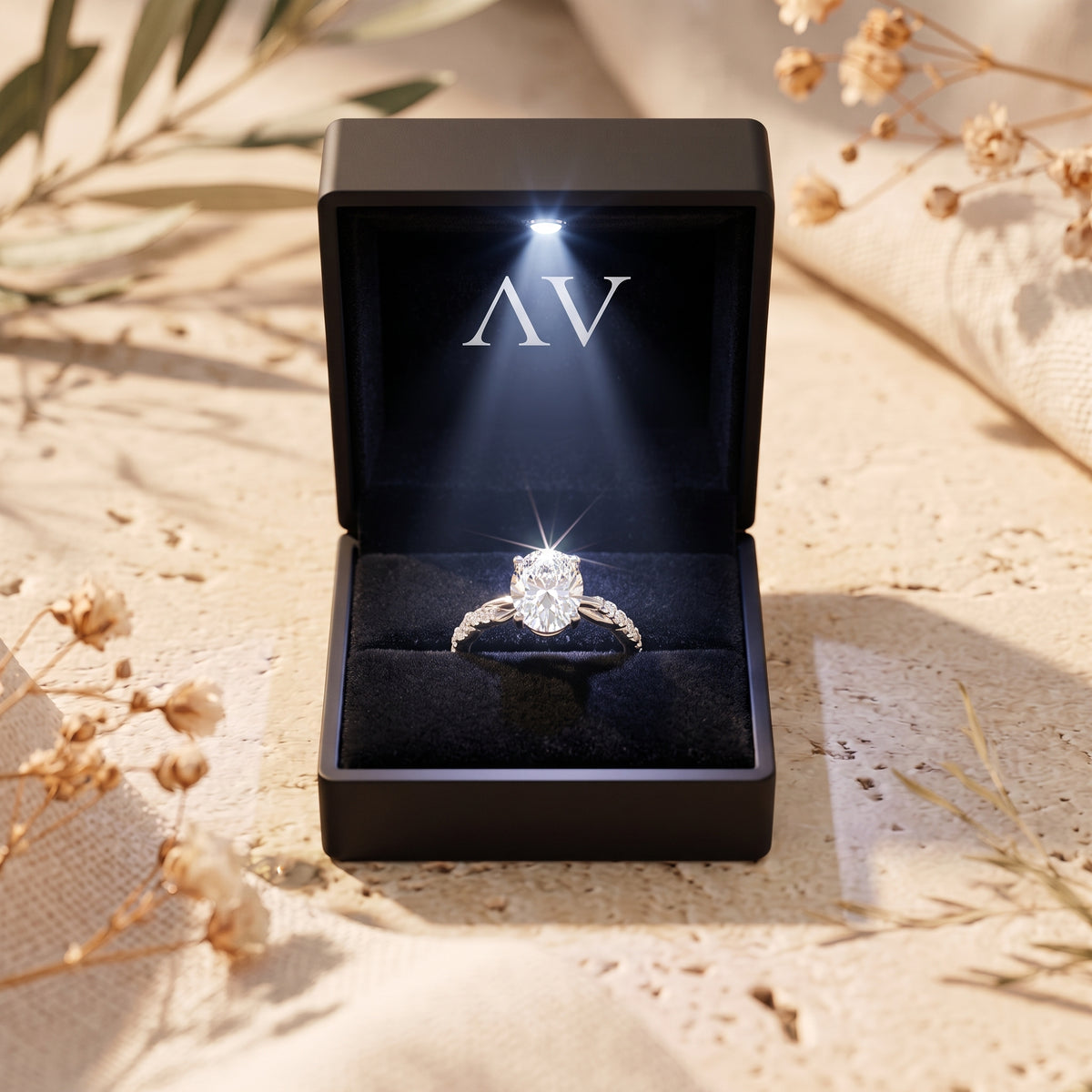 Oval moissanite ring in lit black gift box.
