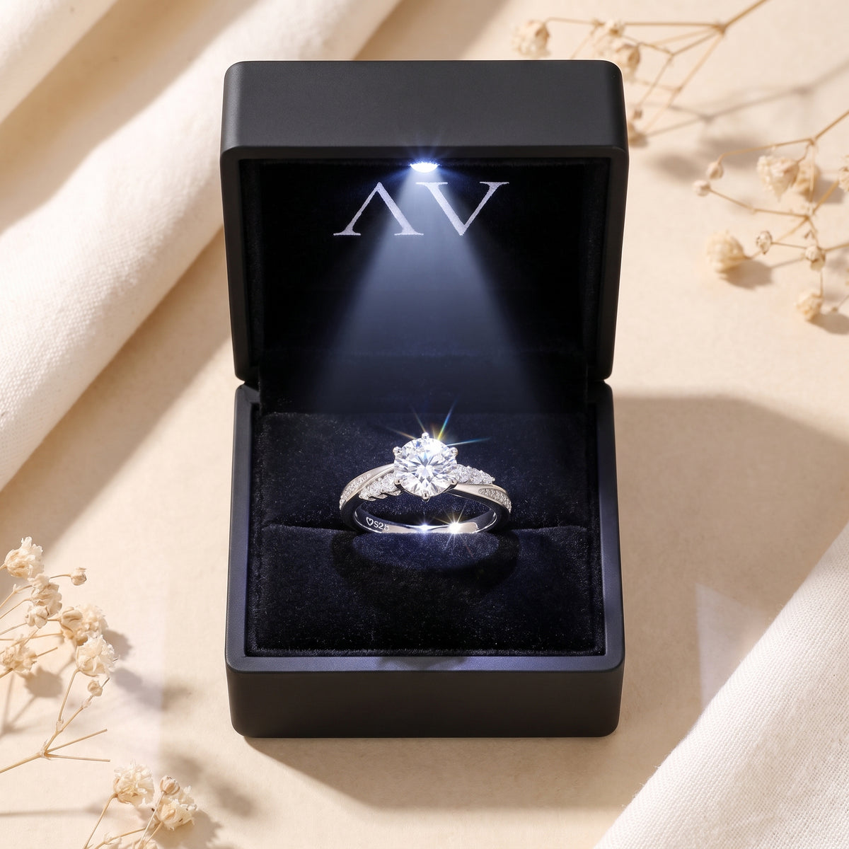 Sterling silver Nicolette moissanite ring in a black LED-lit gift box with a velvet interior.