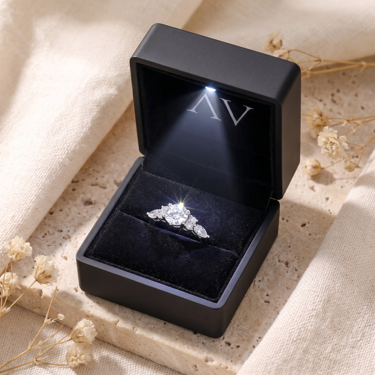 Sterling silver Claraluna ring inside a black lighted gift box with an illuminated center stone.