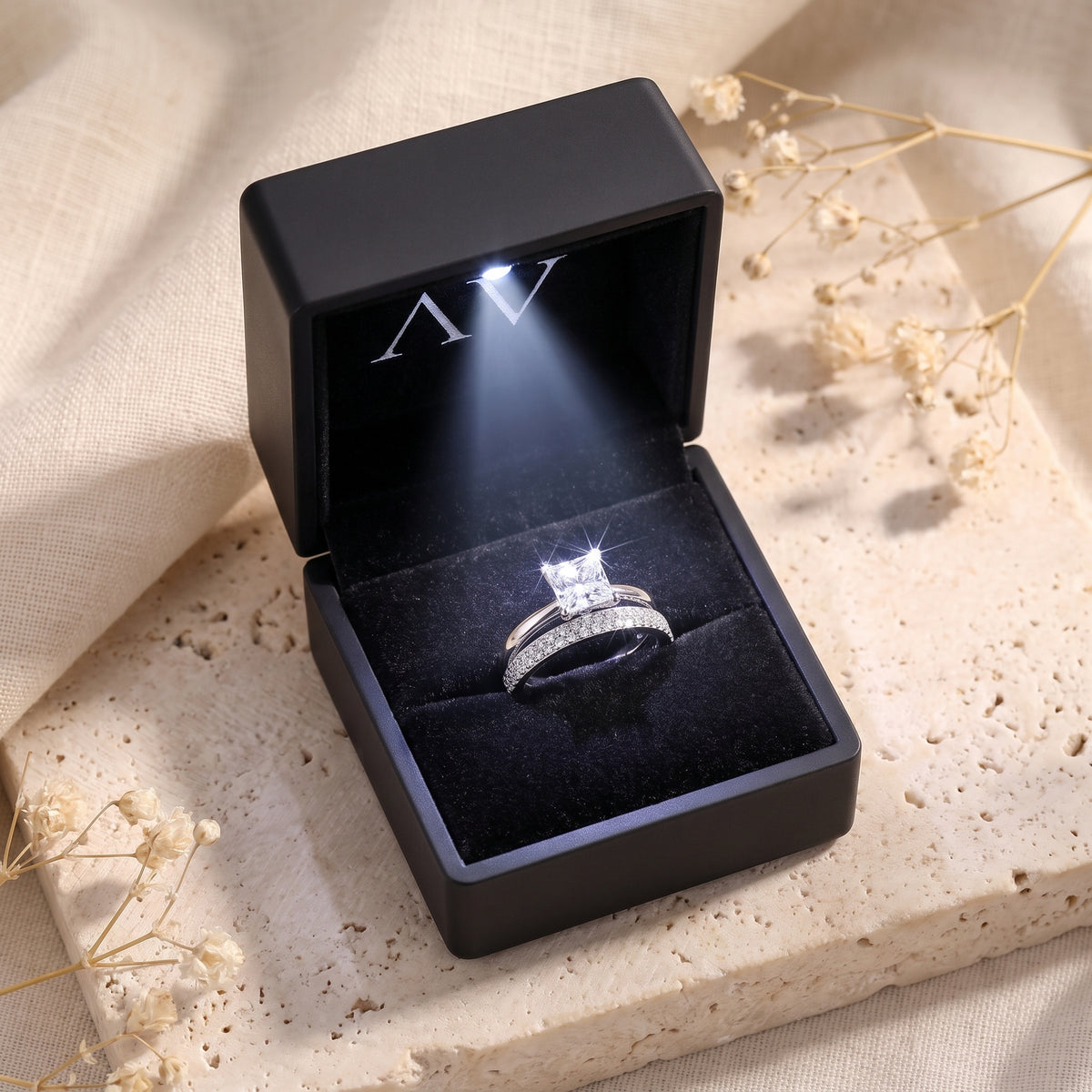 Sterling silver princess cut ring set in a black LED-lit jewelry gift box.