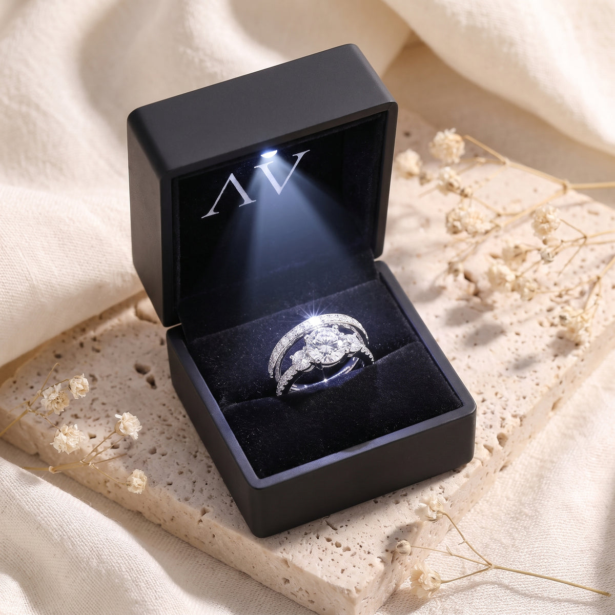Adalicia sterling silver ring set with simulated diamonds in a black LED-lit presentation box.