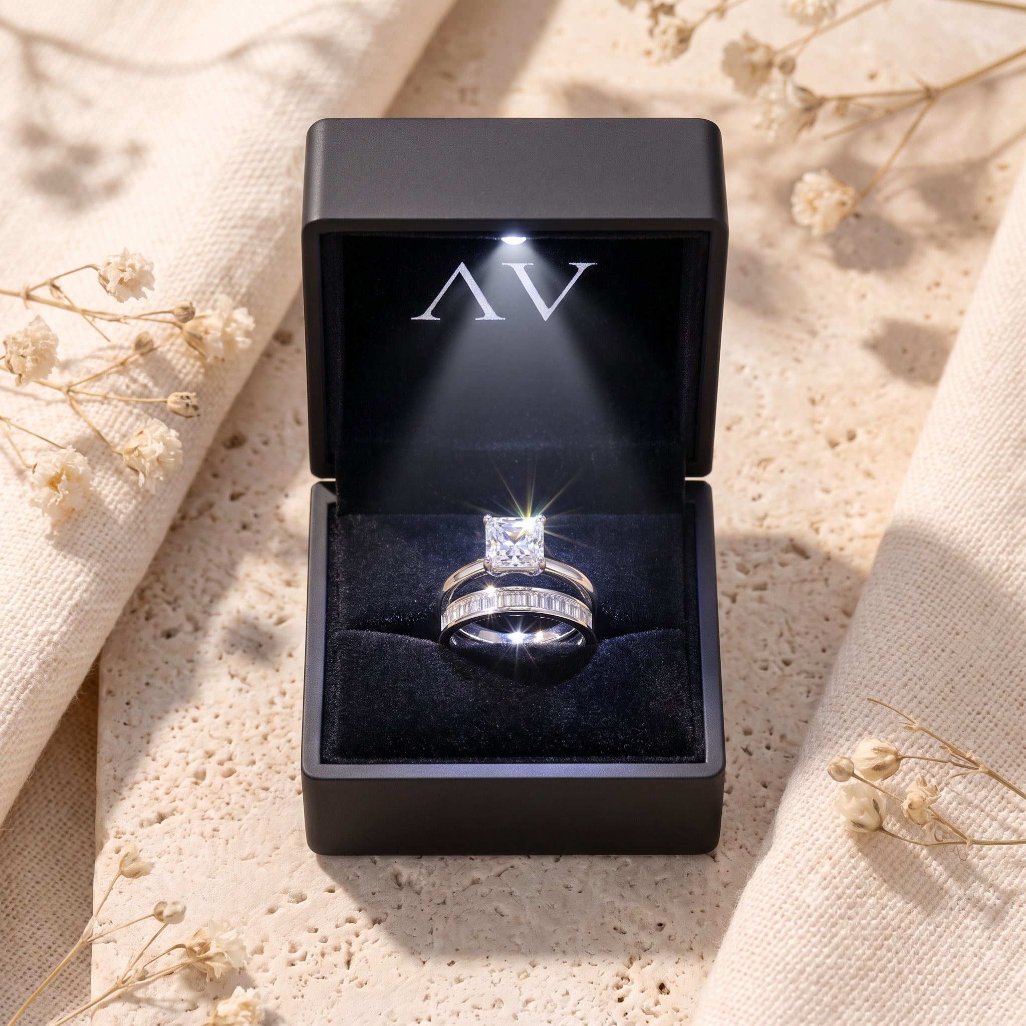 Silver Liorienne ring set with square-cut simulated diamond displayed in a black LED-lit jewelry presentation box.