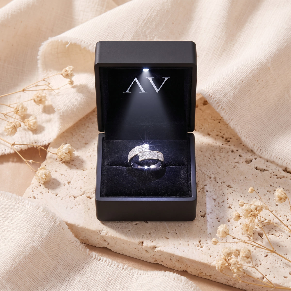 Silver Eldria bypass ring with simulated diamonds inside a black LED-lit jewelry presentation box.