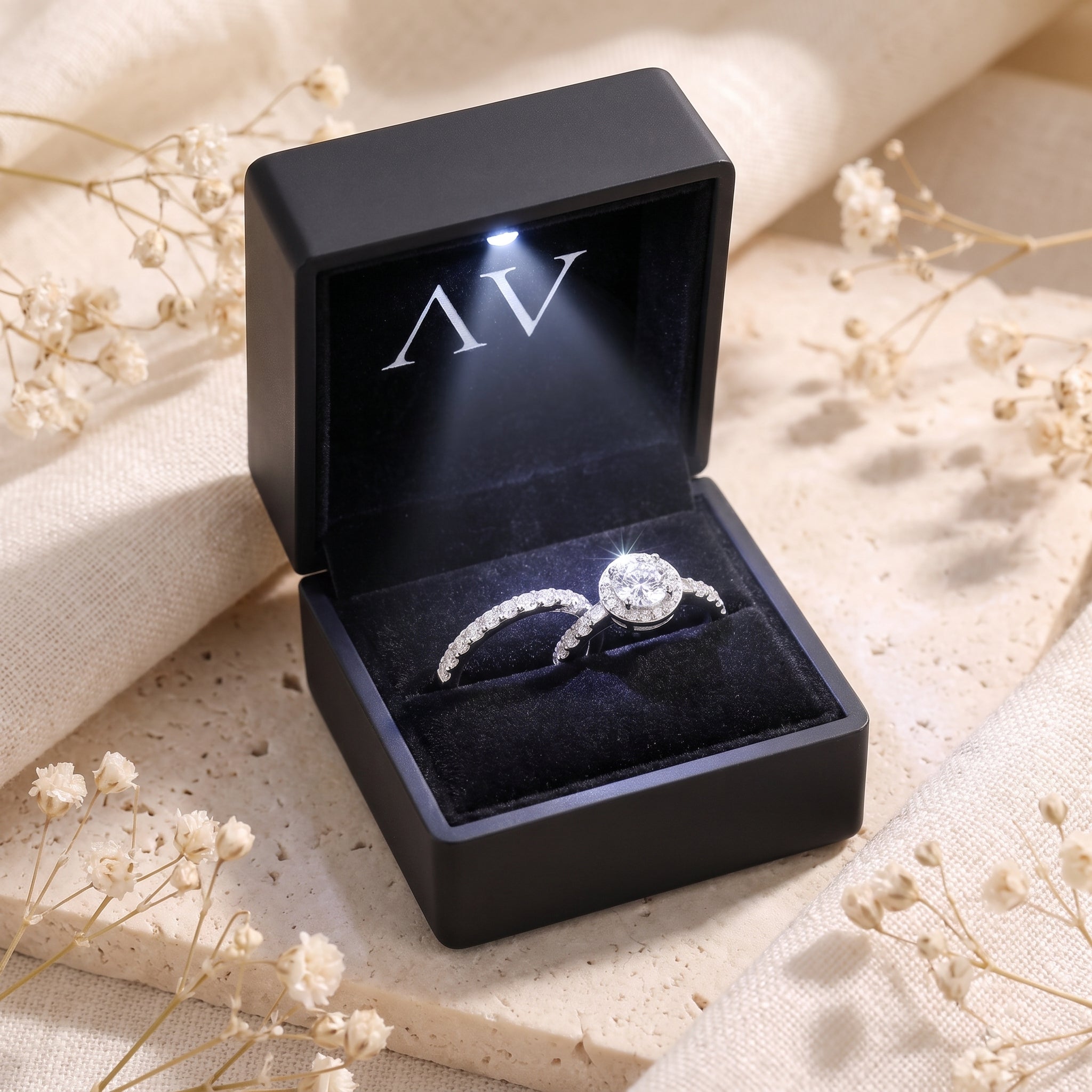 Myrella sterling silver ring set inside a black lighted jewelry box with dried floral accents.