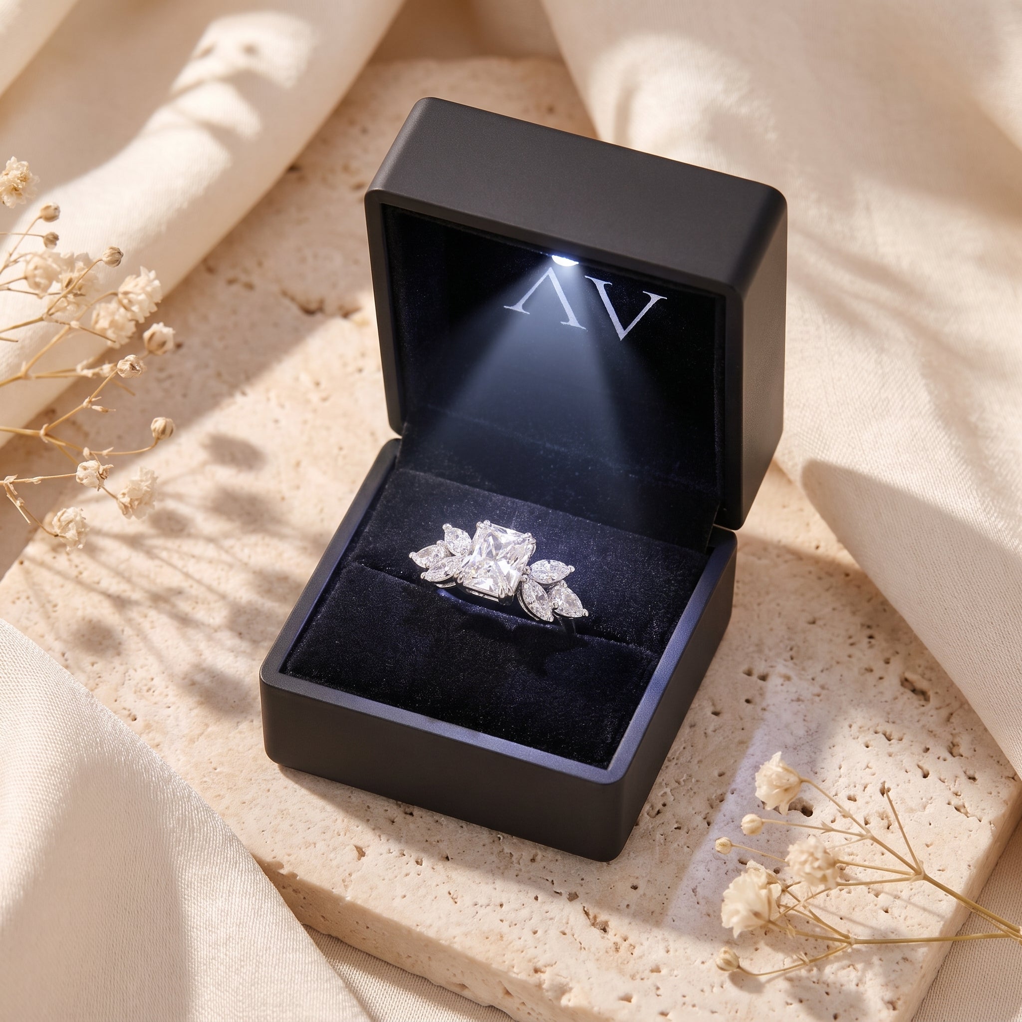 Sterling silver radiant cut simulated diamond ring inside a black LED-lit presentation box.