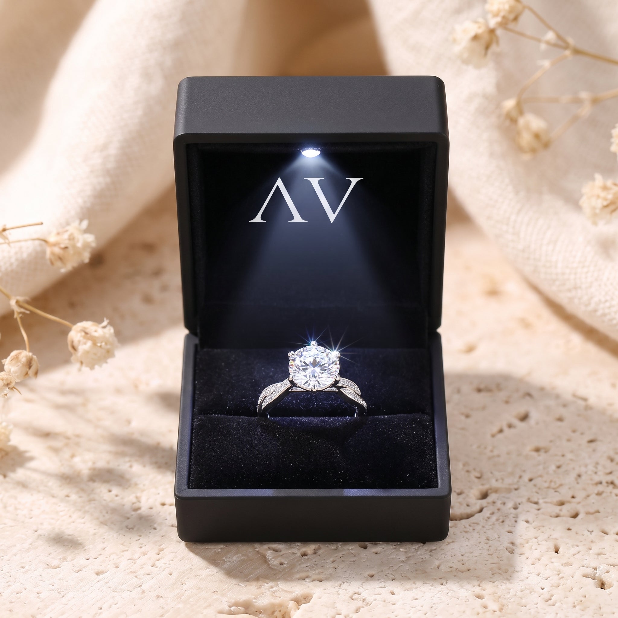 Sterling silver simulated diamond ring presented in a black lighted gift box with the AV logo.