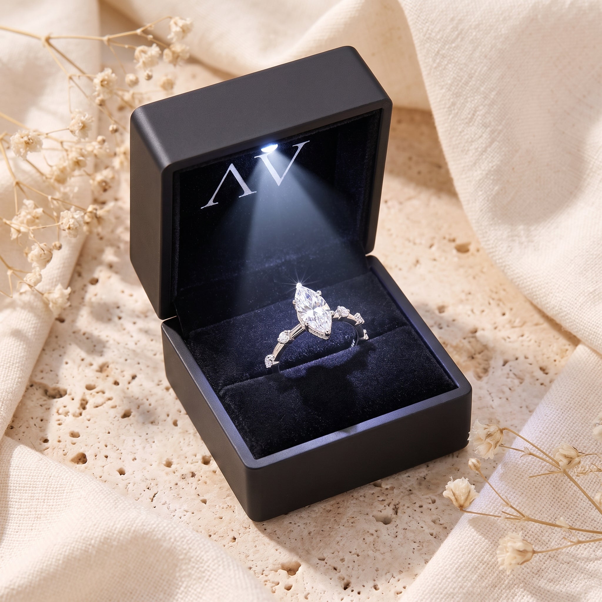 The Isabetta marquise cut simulated diamond ring displayed in a black LED-lit jewelry gift box.