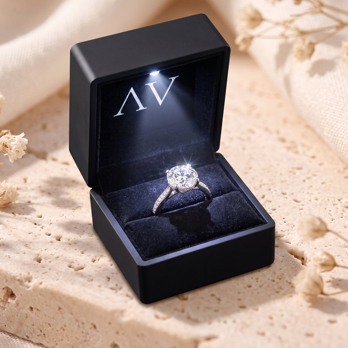 The Iselienne simulated diamond ring presented in a black LED-lit jewelry box with the AV logo.