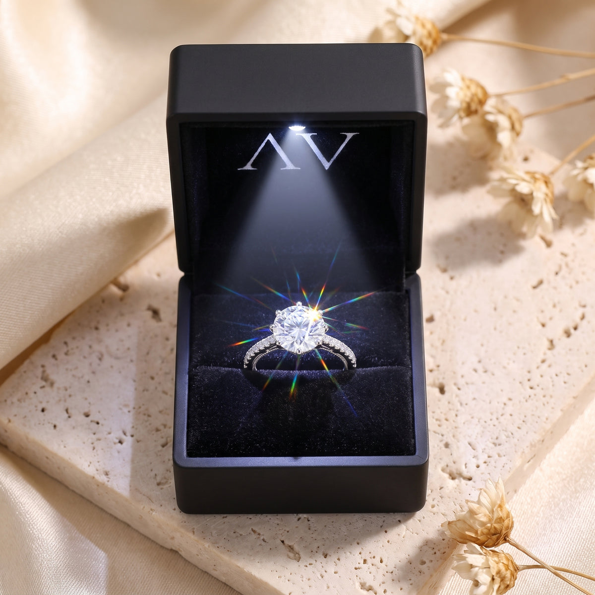 Sterling silver 9mm round CZ solitaire ring inside a black lighted jewelry presentation box.
