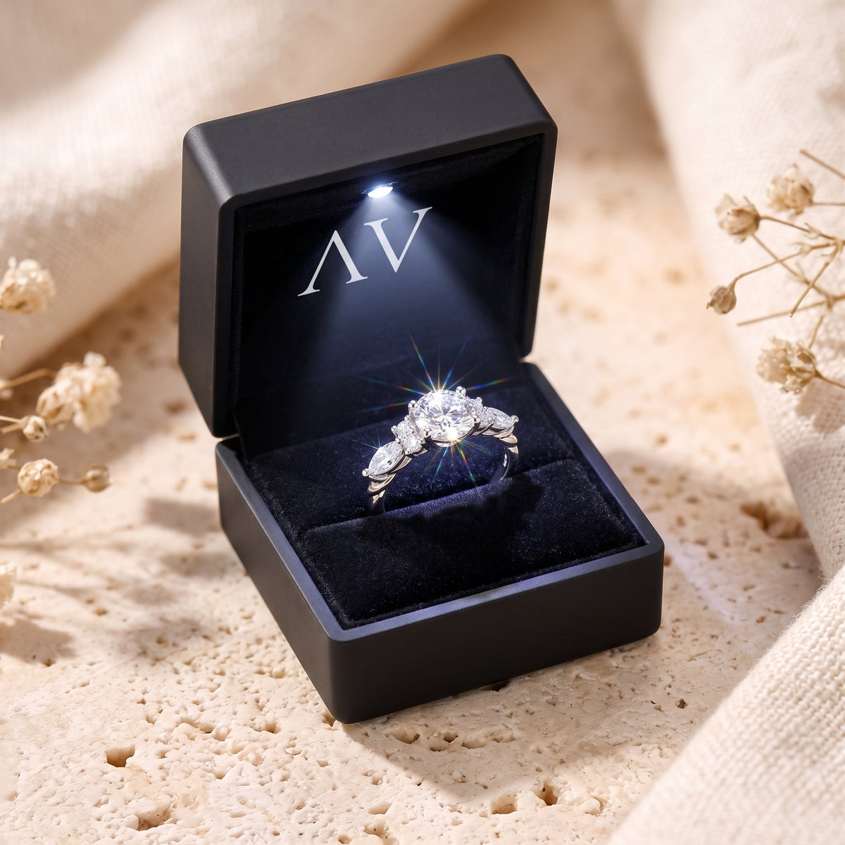 The Carlotta simulated diamond ring in solid gold displayed inside a black LED-lit jewelry gift box.