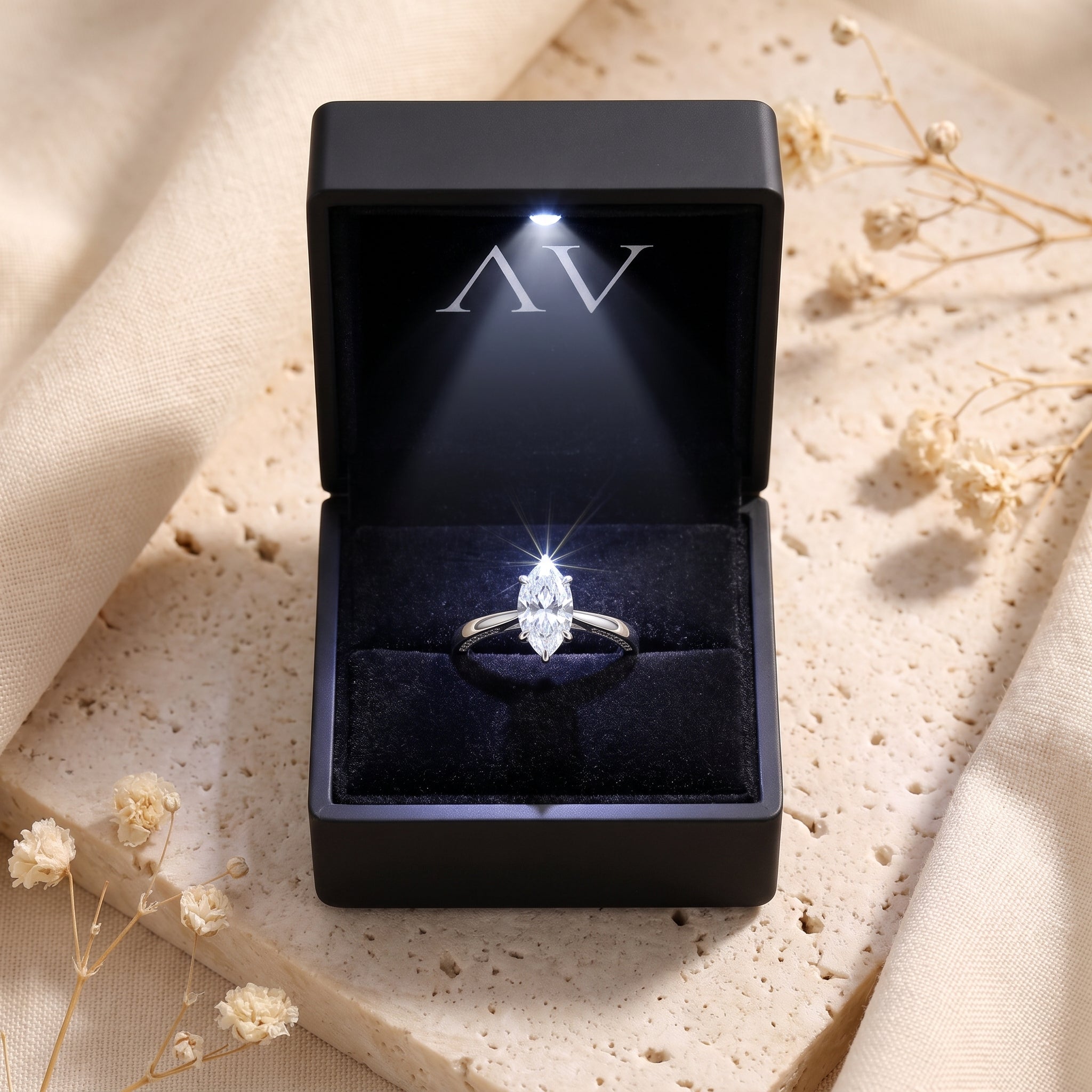 Marquise-cut simulated diamond sterling silver ring presented in a black LED-lit jewelry gift box.