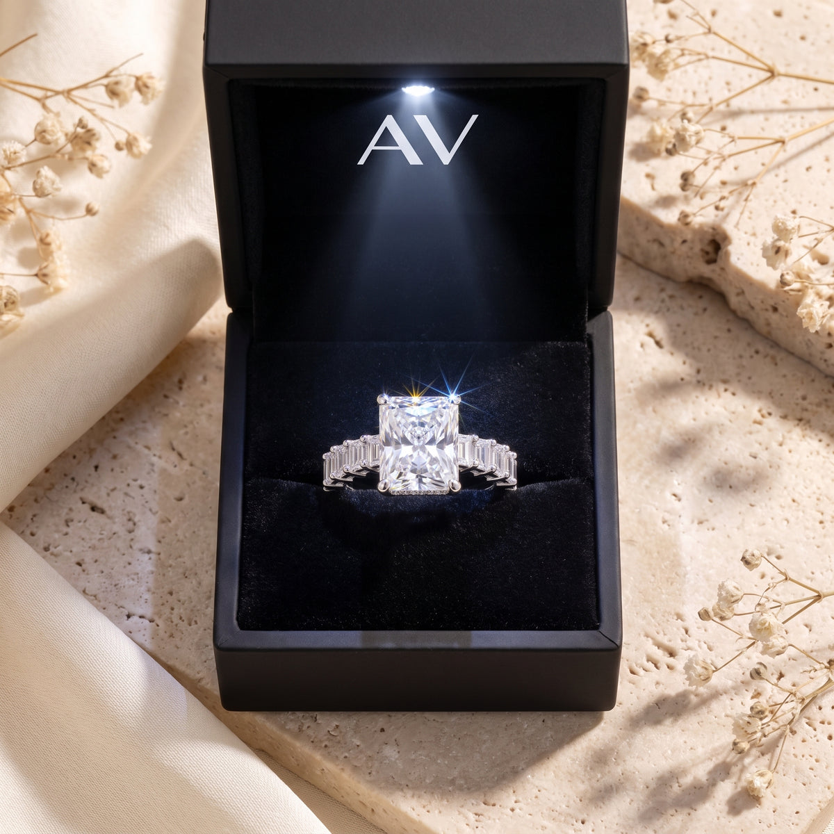 Sterling silver radiant cut simulated diamond ring inside a black LED-lit jewelry gift box.