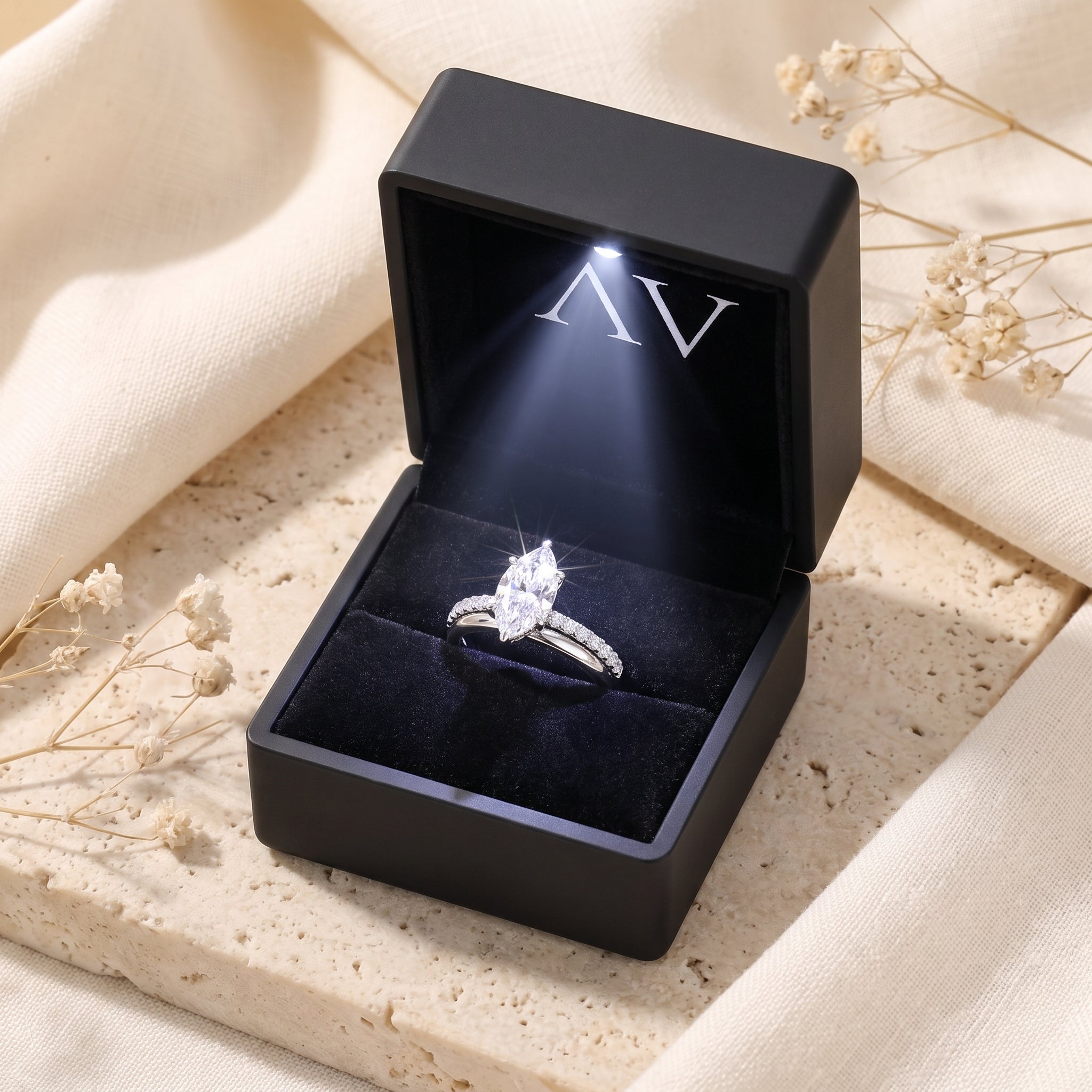 Marquise simulated diamond sterling silver ring displayed in a premium black lighted jewelry gift box.