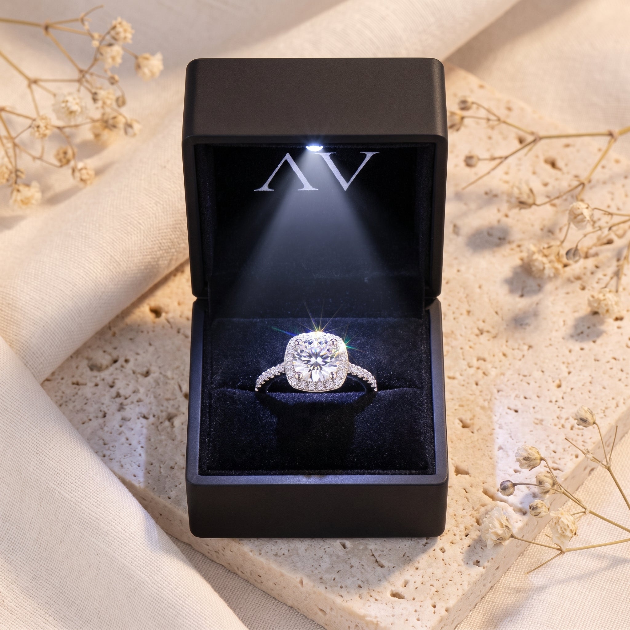 The Elianessa round cut simulated diamond halo ring in silver S925 sterling silver inside a black LED gift box.