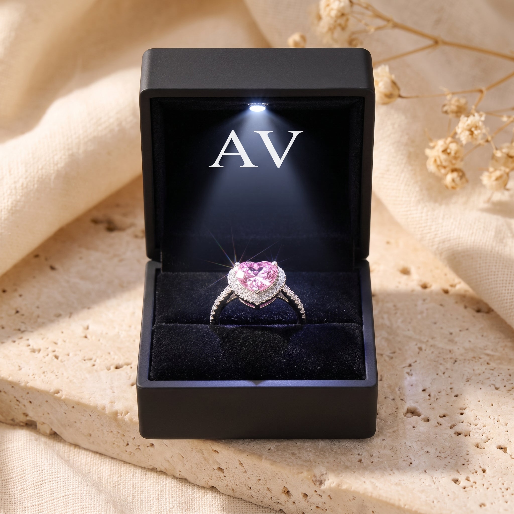 Heart-shaped simulated pink tourmaline sterling silver ring presented in a black LED-lighted jewelry box.