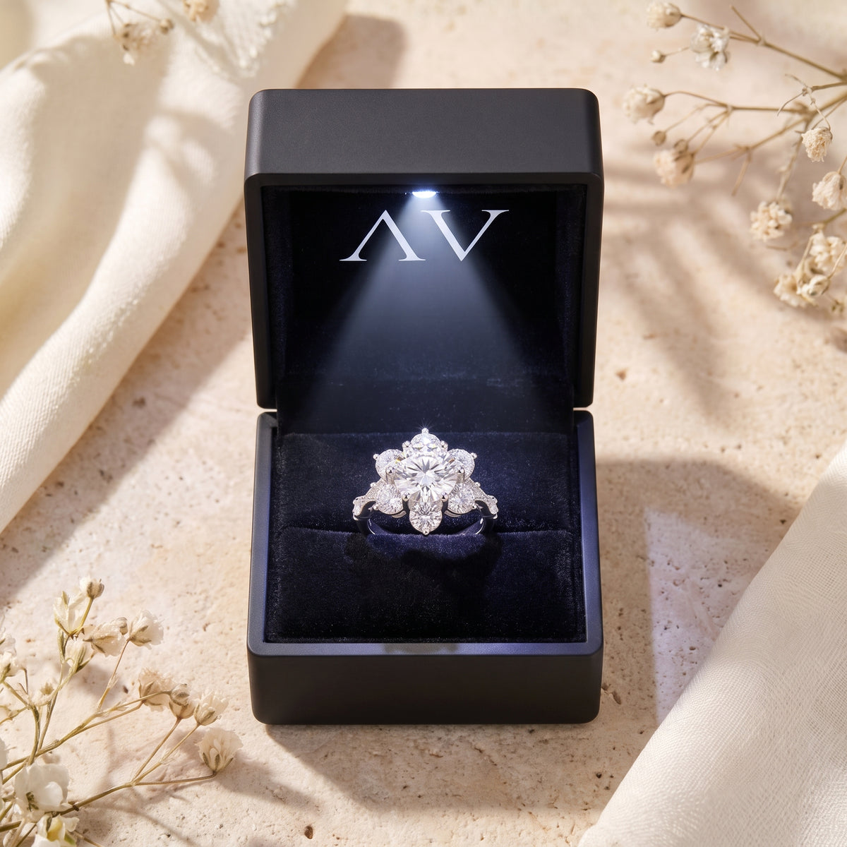 Roselita silver ring with round simulated diamond inside a black LED-lit presentation box.