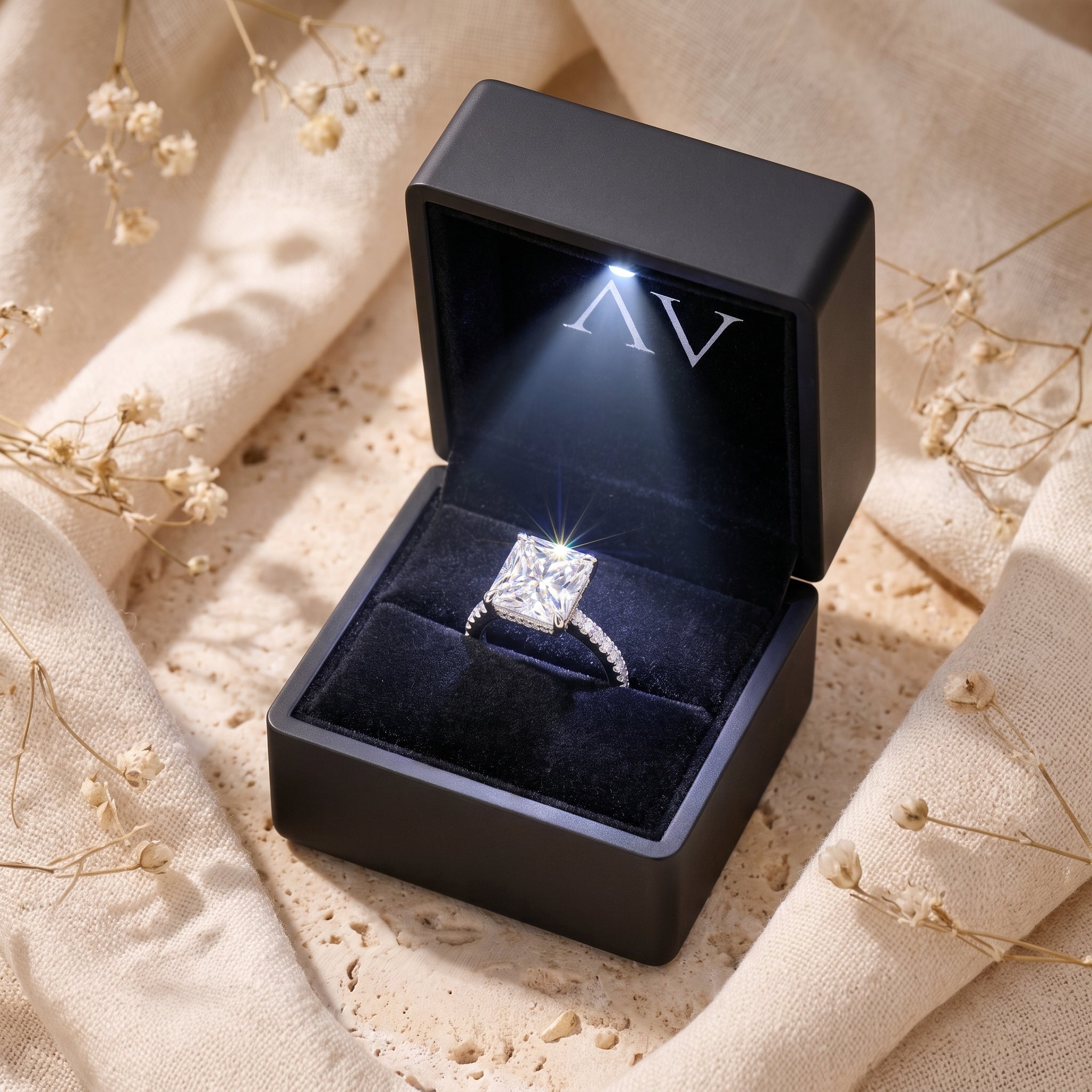 The Claudette radiant-cut CZ sterling silver ring presented in a black LED-lit jewelry gift box.