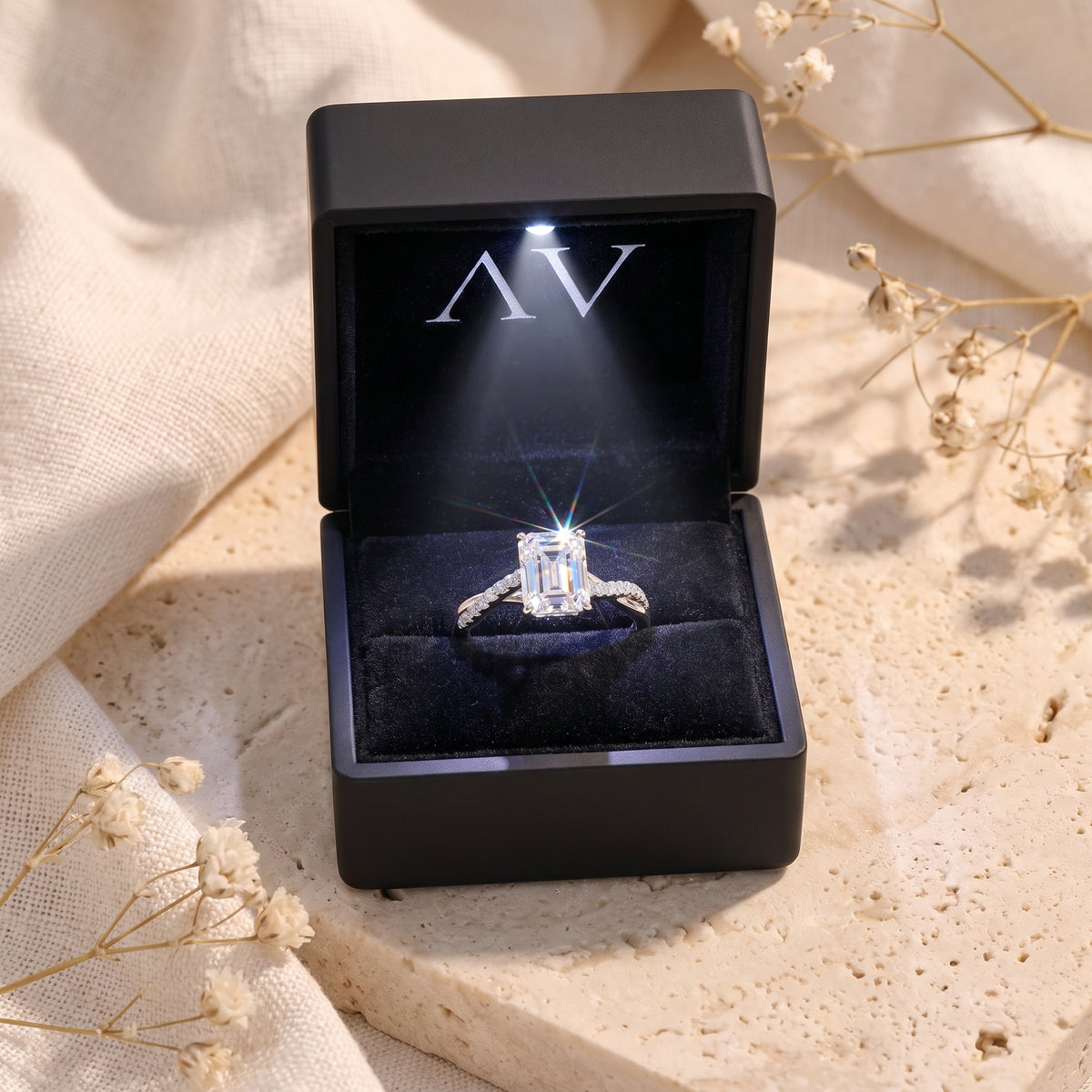 Silver emerald cut CZ promise ring presented in a premium black LED-lit jewelry gift box.