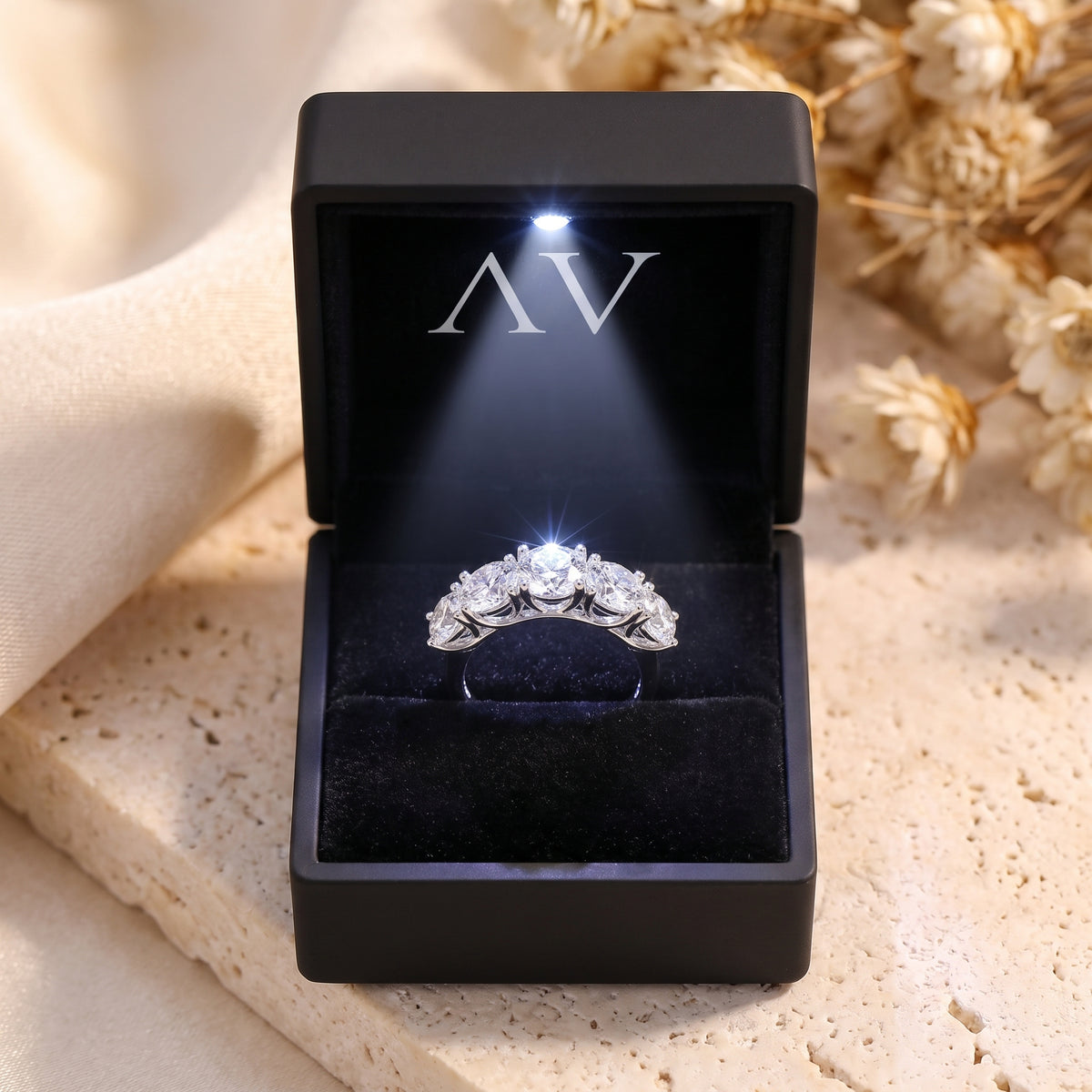 The Claralise five-stone simulated diamond ring in sterling silver presented in a black LED-lighted jewelry box.