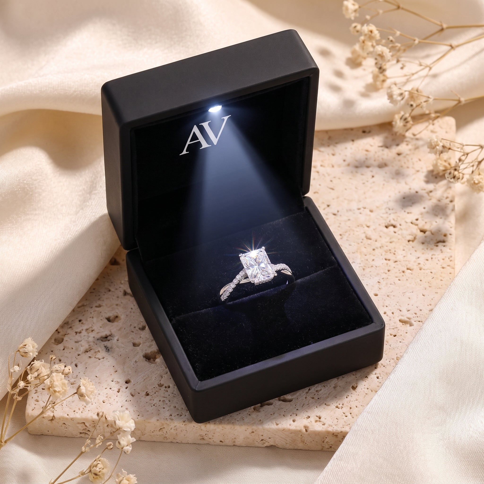 Sterling silver radiant cut simulated diamond ring in a black LED-lit gift box.