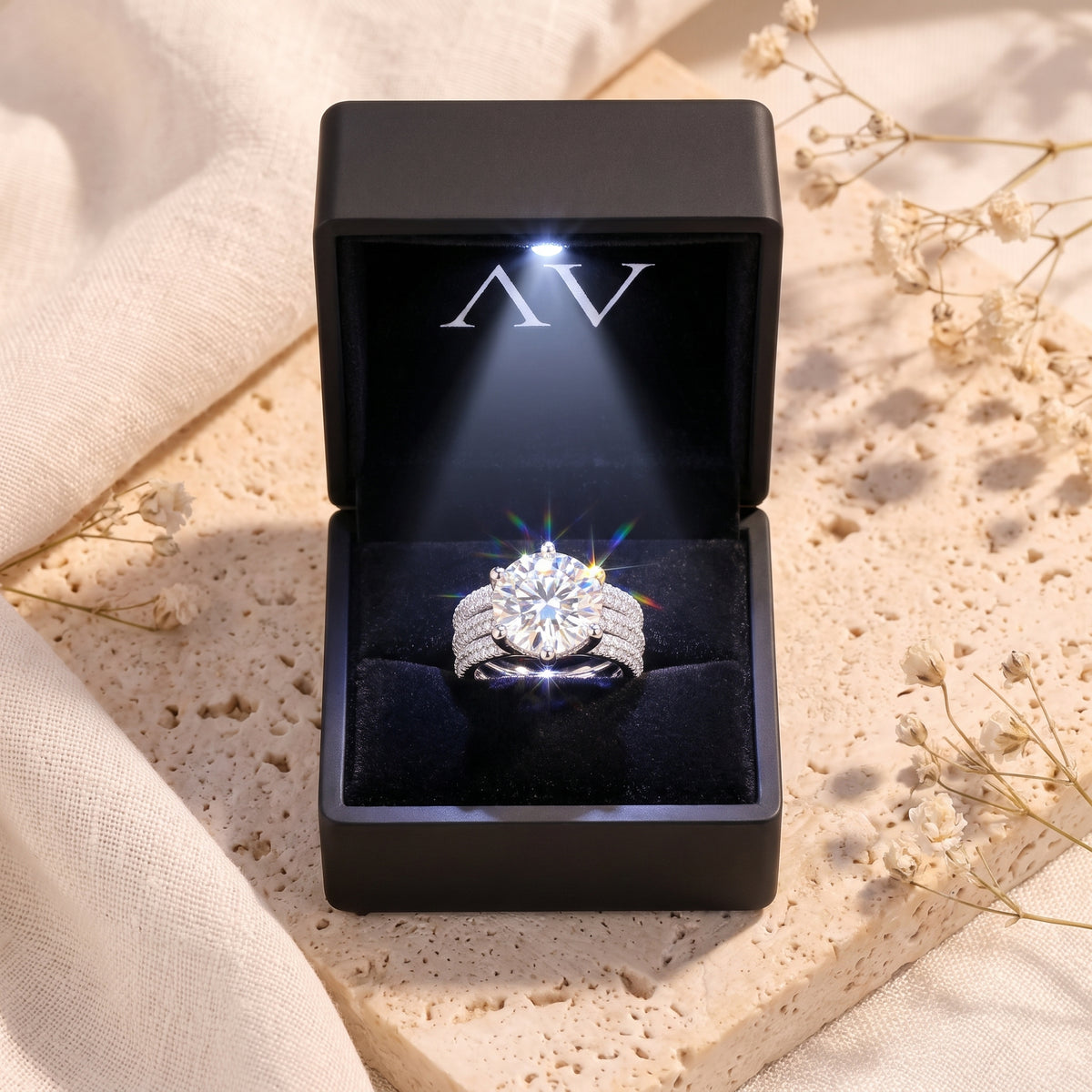 Sterling silver round simulated diamond ring in black LED-lit gift box.