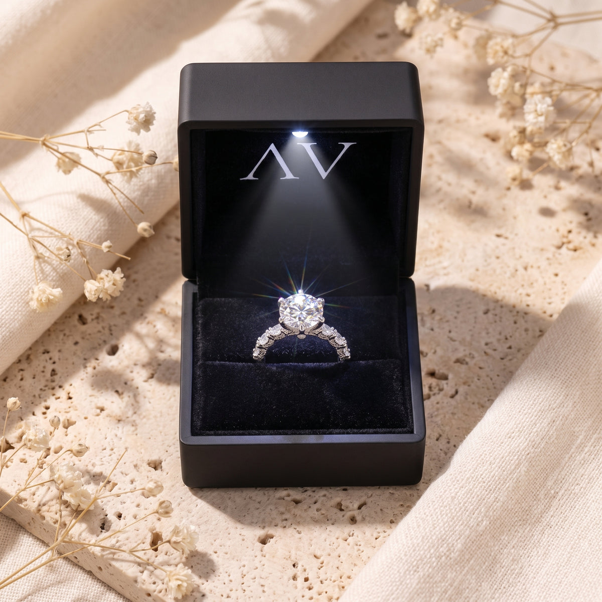 Stella silver promise ring displayed in a black LED-lit presentation box.