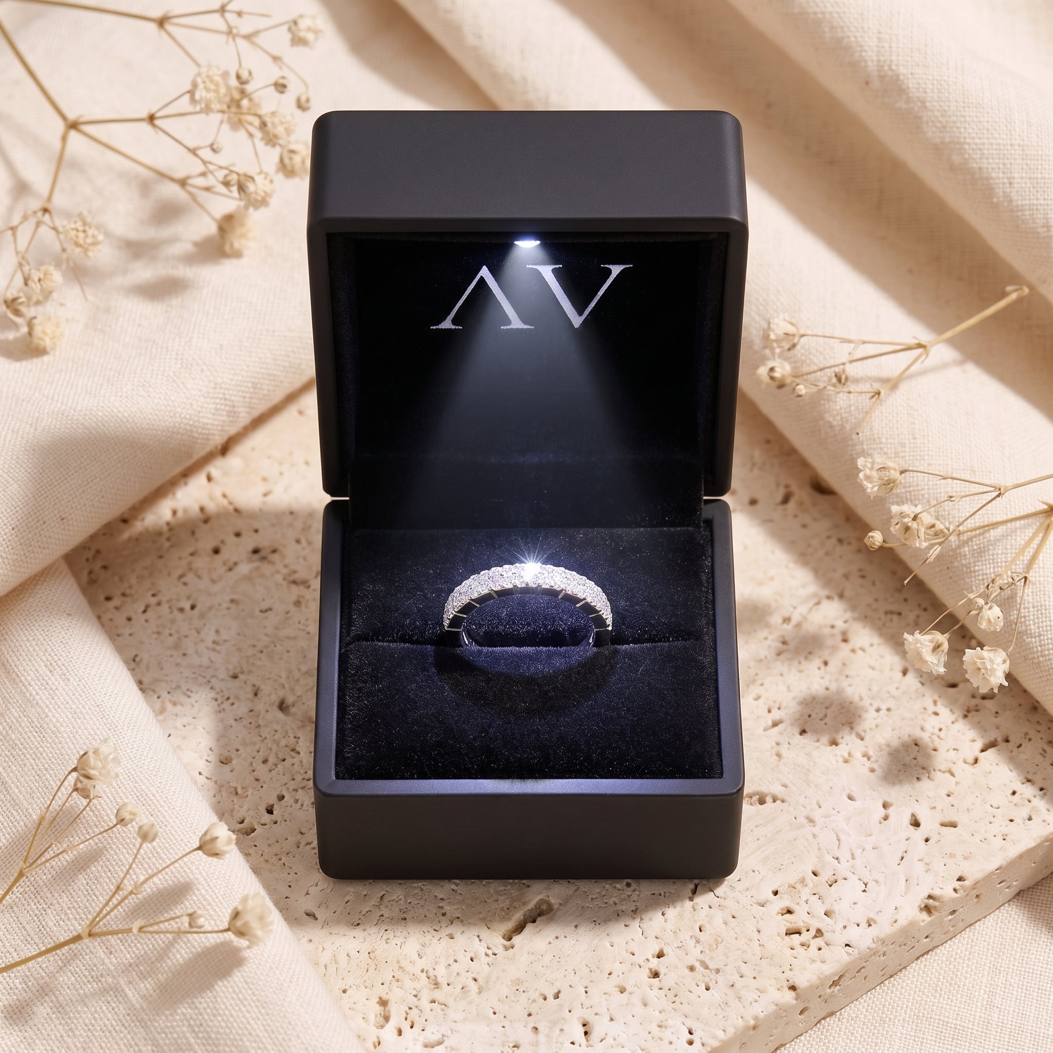 Silver double row pavé ring inside a black LED-lit jewelry presentation box.