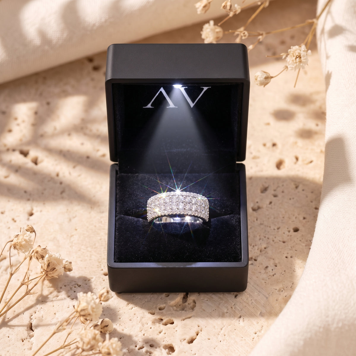 Sterling silver multi-row cubic zirconia ring inside a black illuminated gift box.