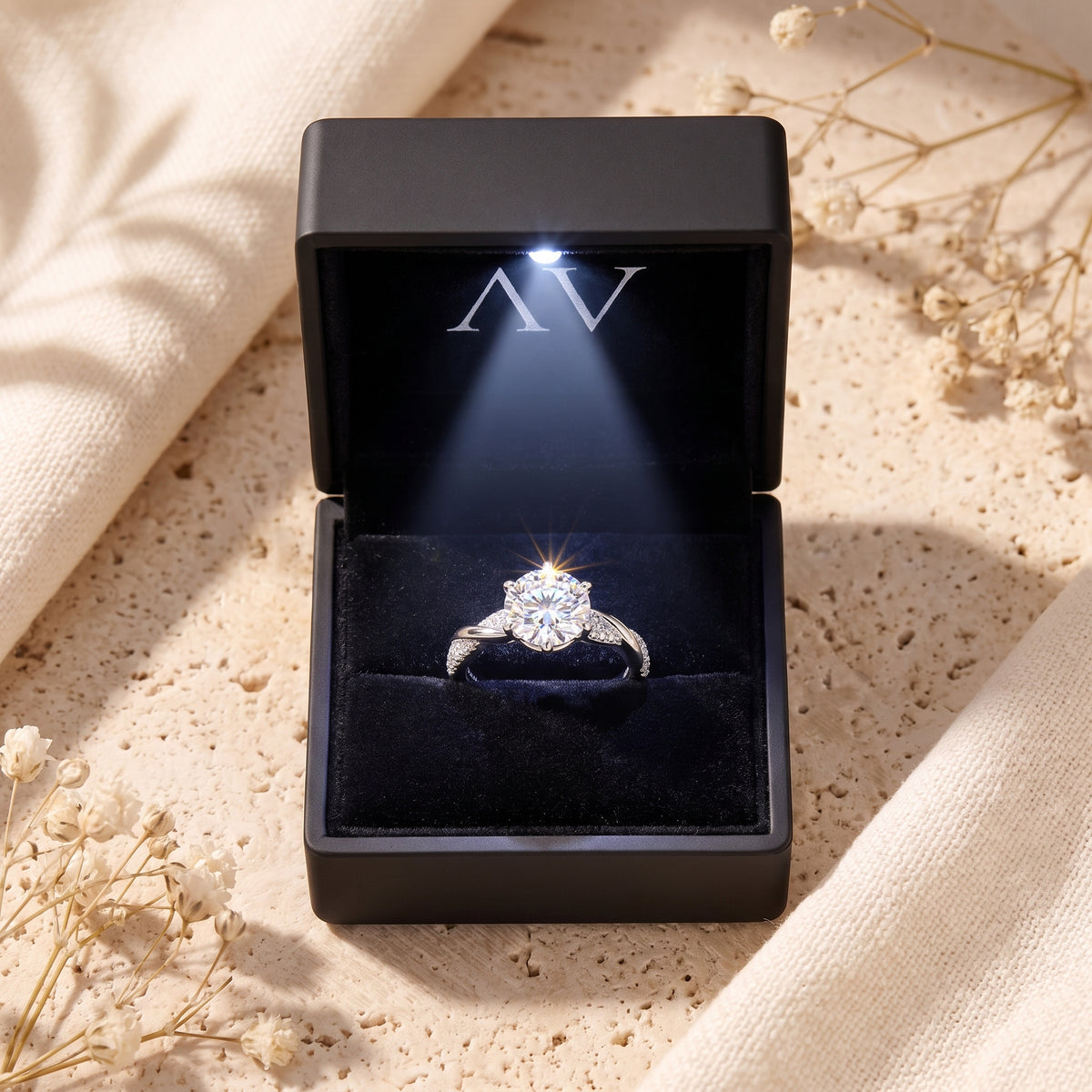 Silver Neridelle promise ring inside a black lighted presentation box.