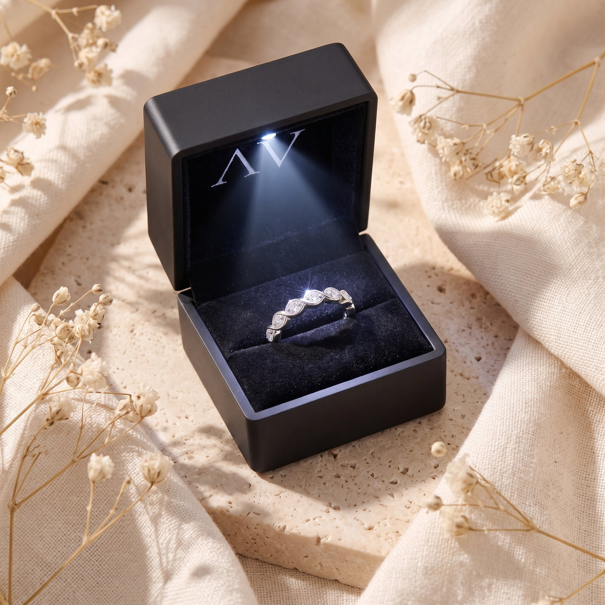 The Amandelle sterling silver simulated diamond ring inside a premium black lighted presentation box.