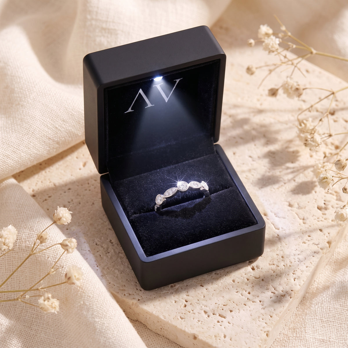 Sterling silver cubic zirconia ring inside a black LED-lit presentation box.