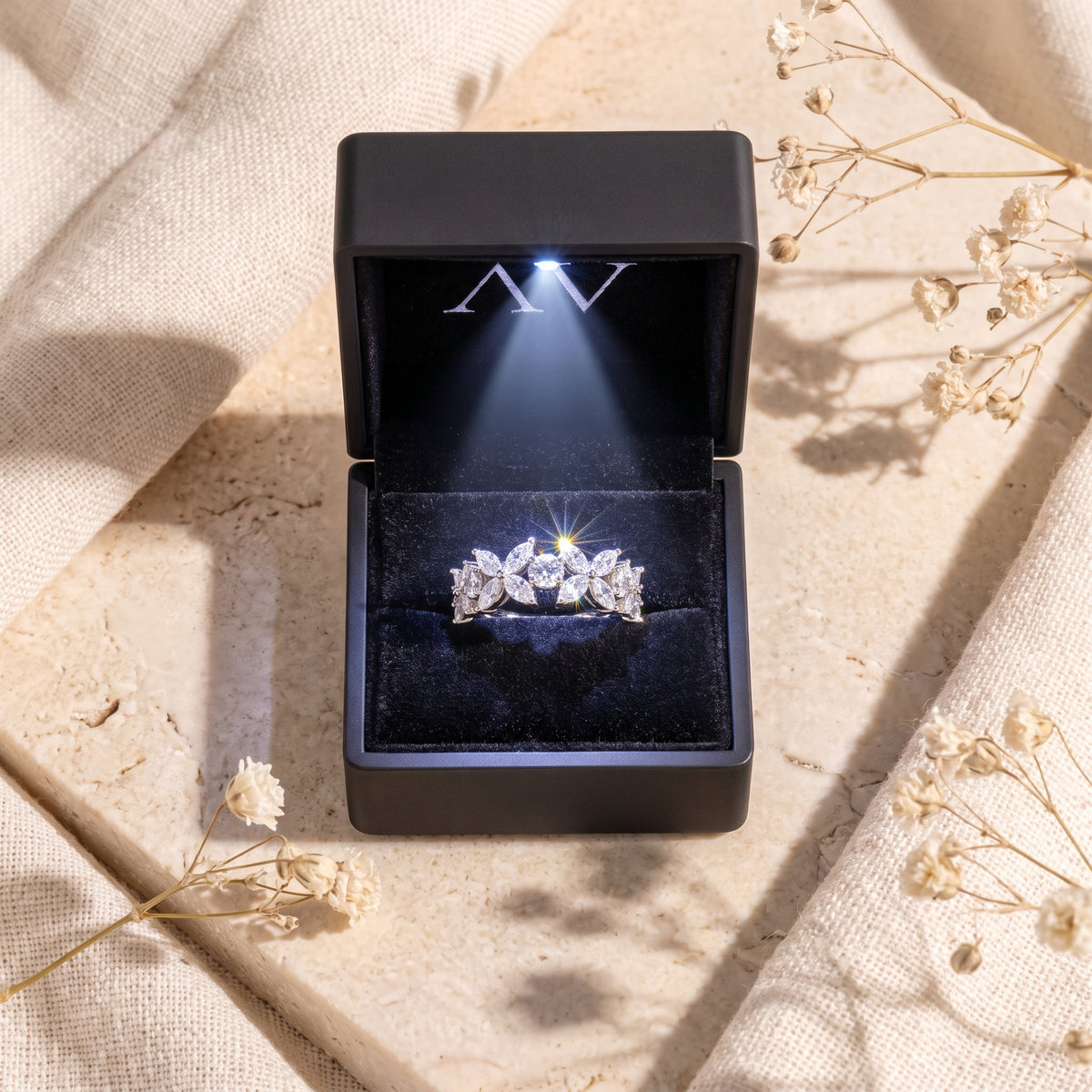 Silver marquise zircon floral ring inside a black LED-lit jewelry presentation box.