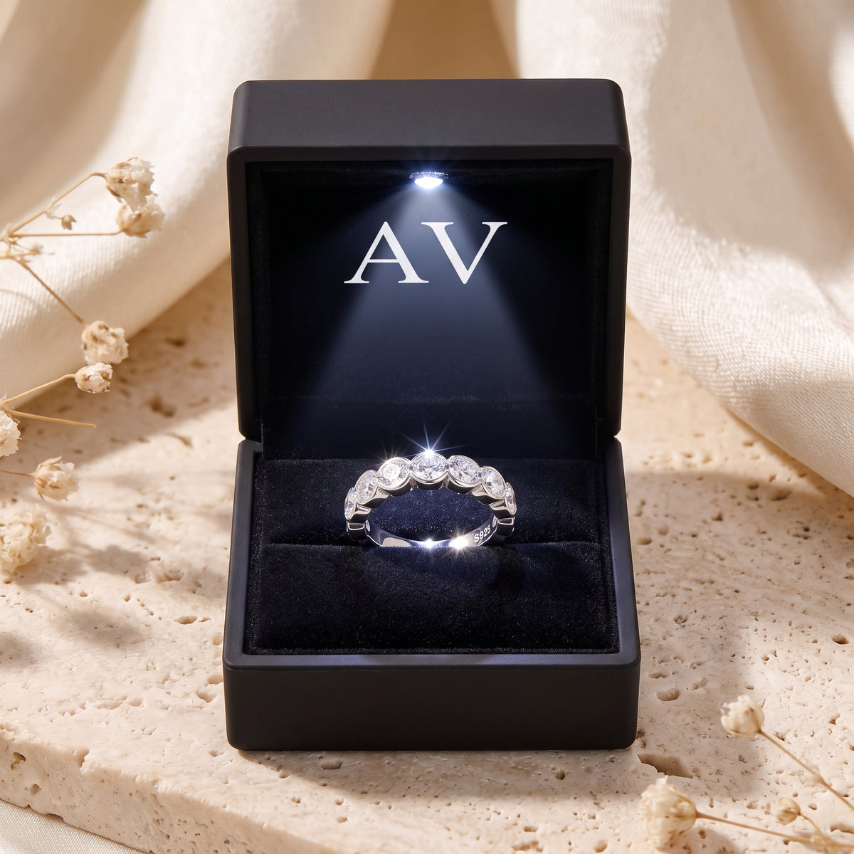 The Zarielle sterling silver eternity ring presented in a black LED-lit jewelry gift box with AV branding.