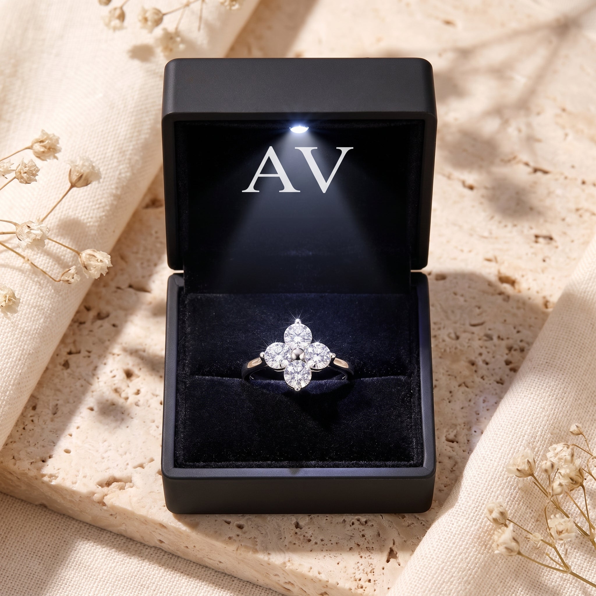 Silver clover promise ring presented in a black lighted gift box with AV branding.