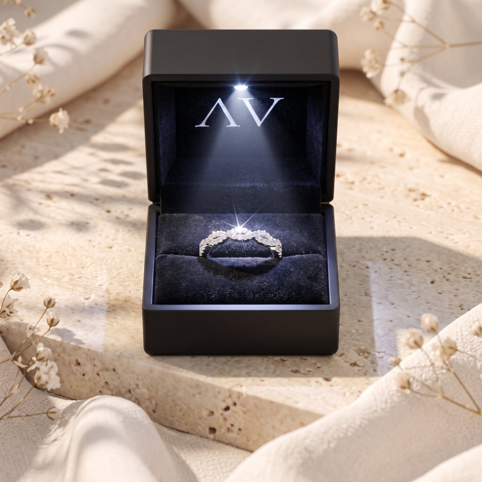 Helena twisted silver ring with simulated diamonds inside a black LED-lit jewelry presentation box.