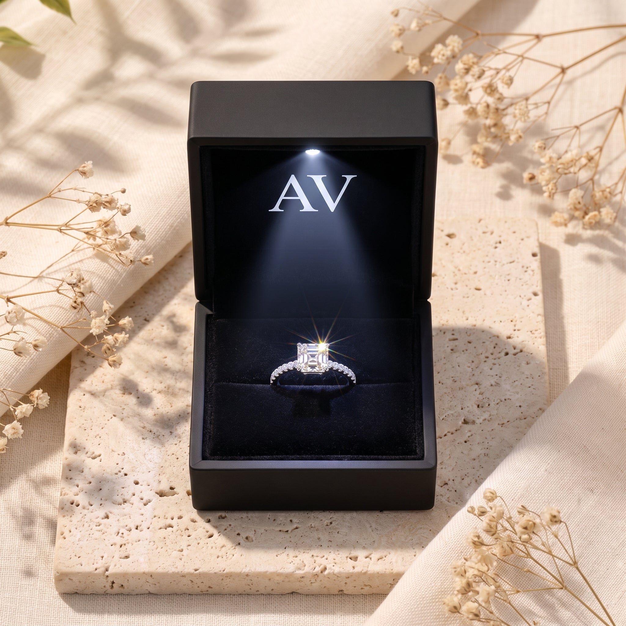 Princess cut CZ silver ring in a lighted black gift box.