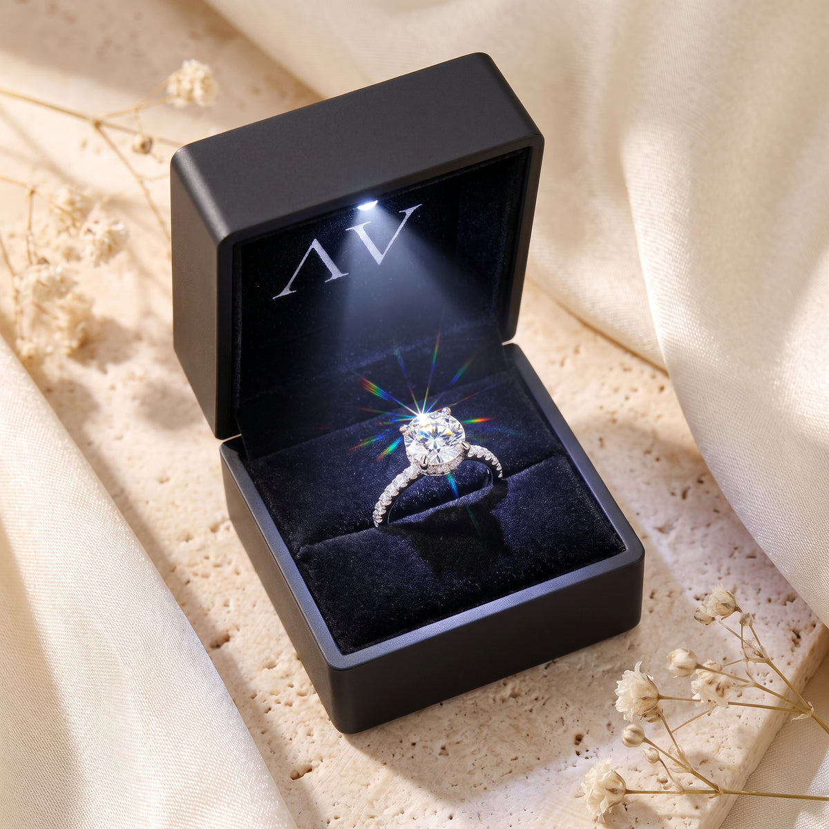 The Elorina sterling silver ring presented in a black LED-lit gift box, highlighting the simulated diamond's sparkle.