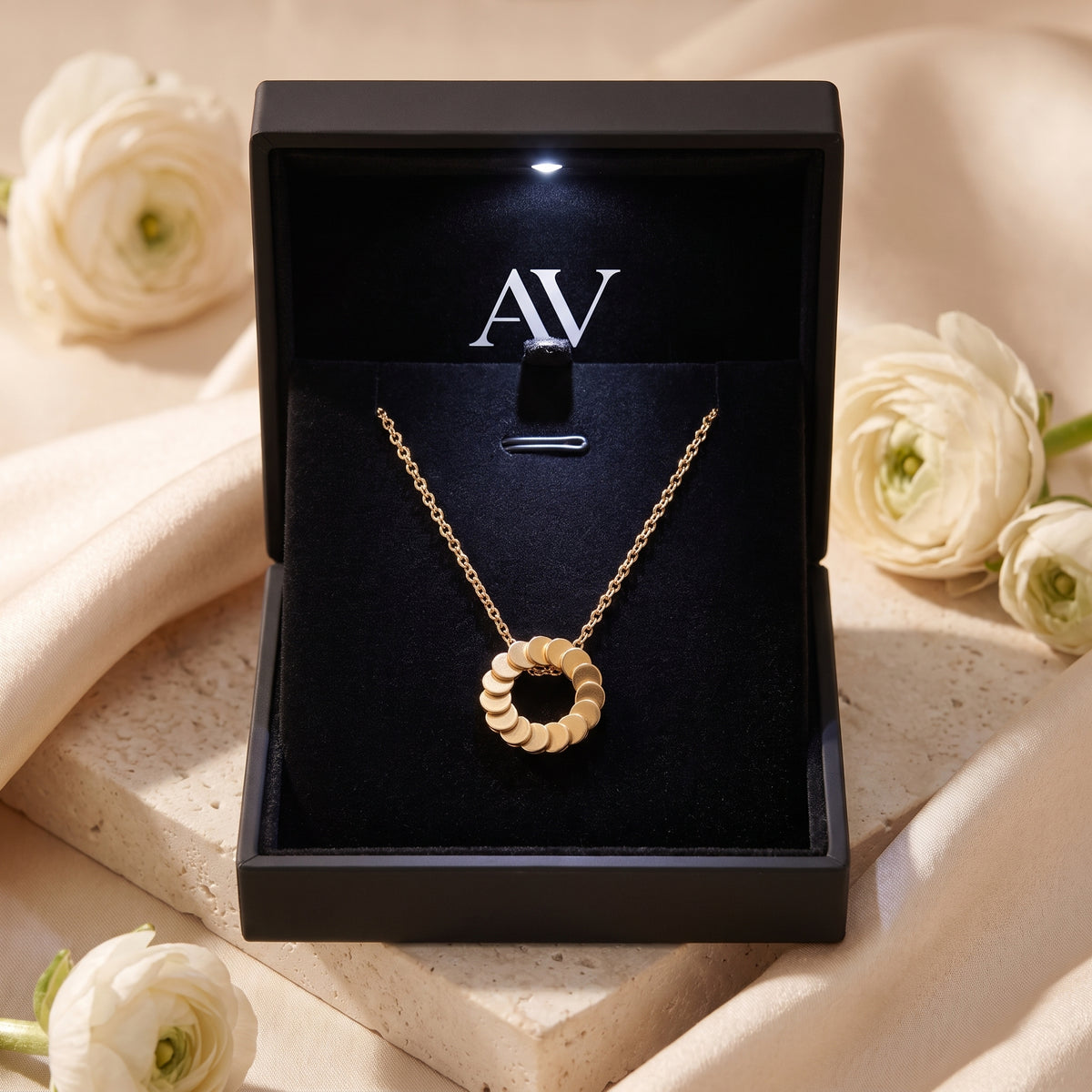 Freya 18K gold plated necklace displayed in a black illuminated jewelry gift box.