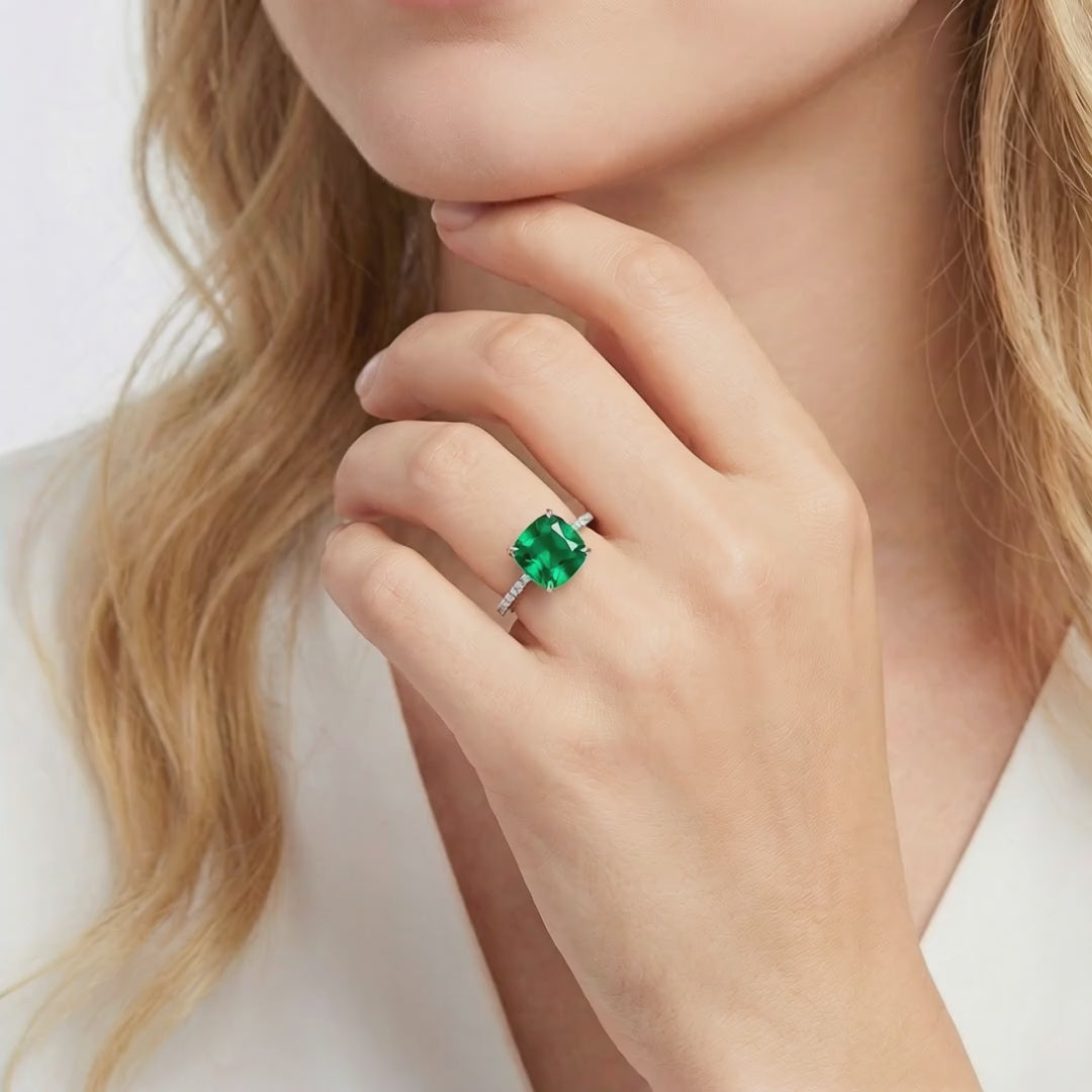 Solid gold ring with cushion-cut simulated emerald.