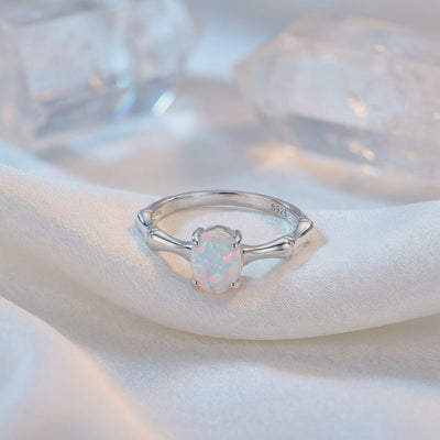 Solid gold ring featuring a natural opal gemstone.