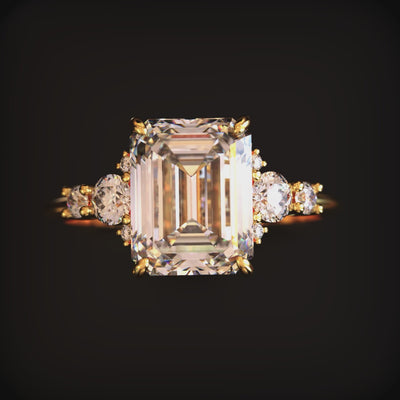 A ring with a 3 carat emerald-cut moissanite in solid gold.
